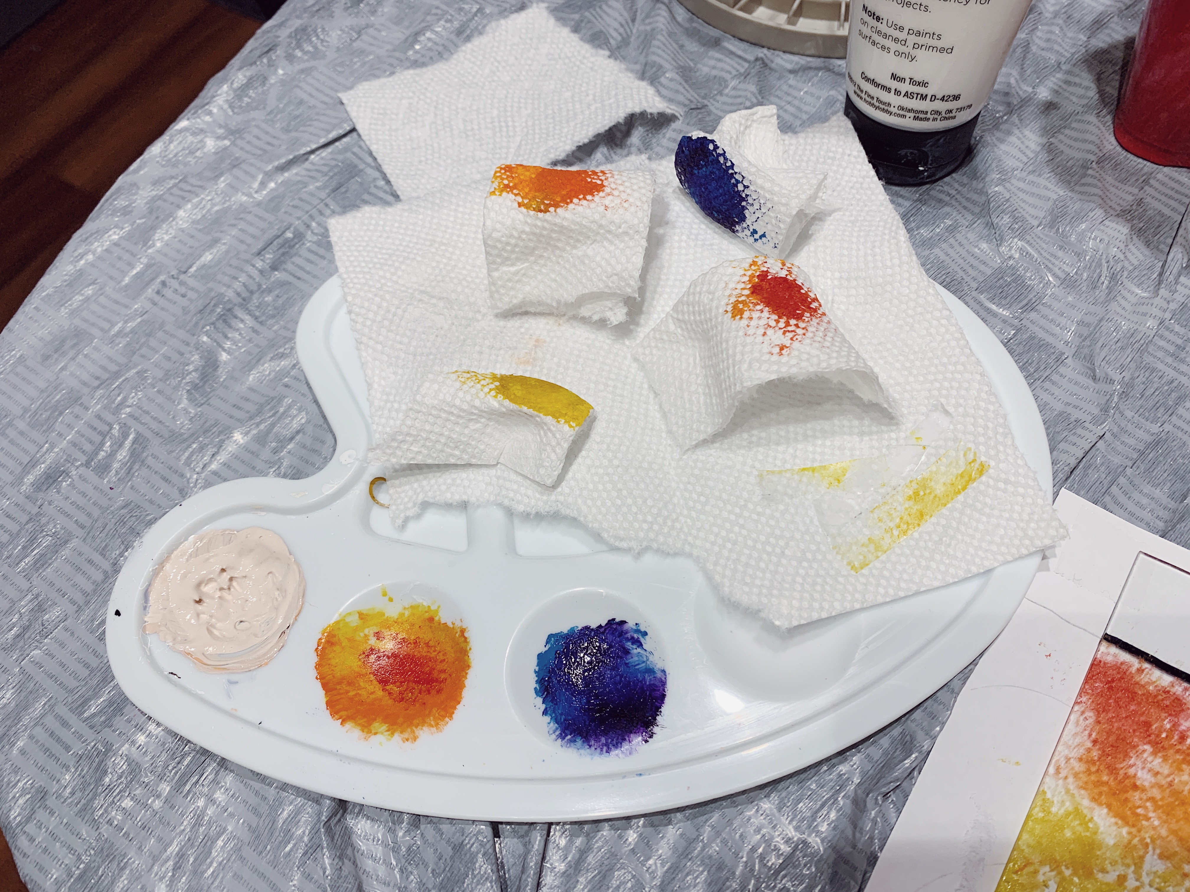 A photo of a paint palette with dabbed paper towels