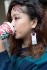 portrait of Siri Svay cosplaying as Demon Slayer character Tanjiro Kamado with Starbucks coffee cup